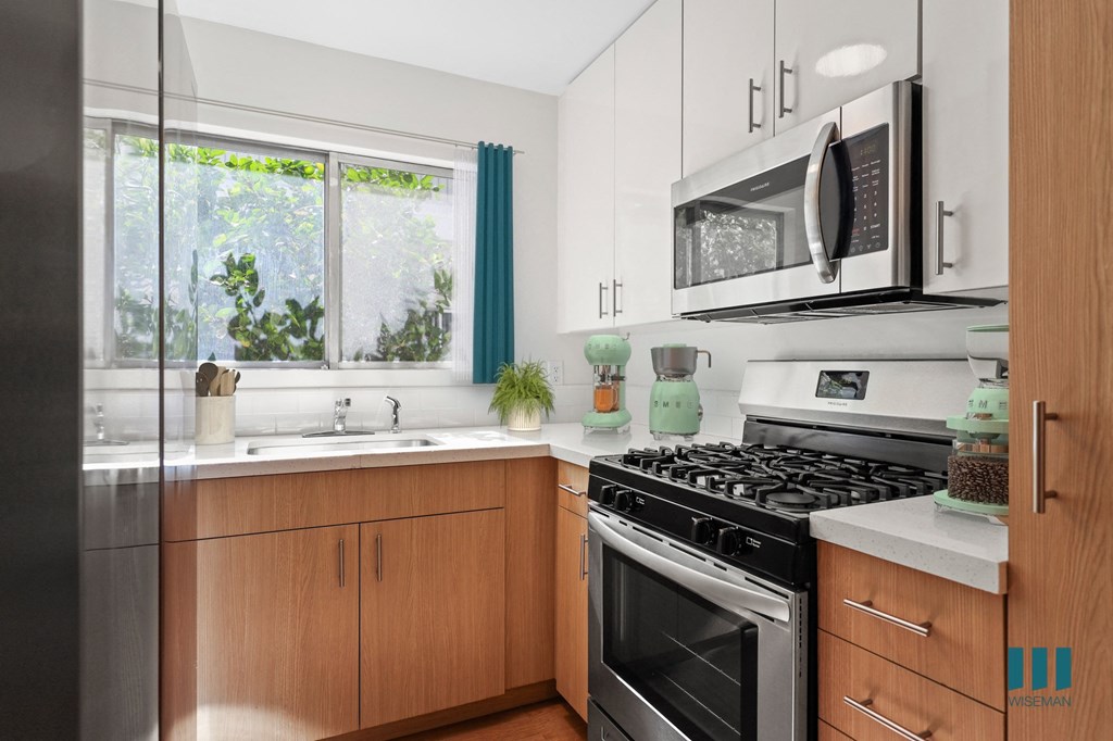 a kitchen with stainless steel appliances and wooden cabinets