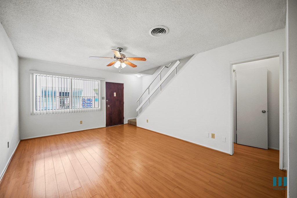 Entryway and Living Room with a Stairwell to the Upper Level of a Townhome