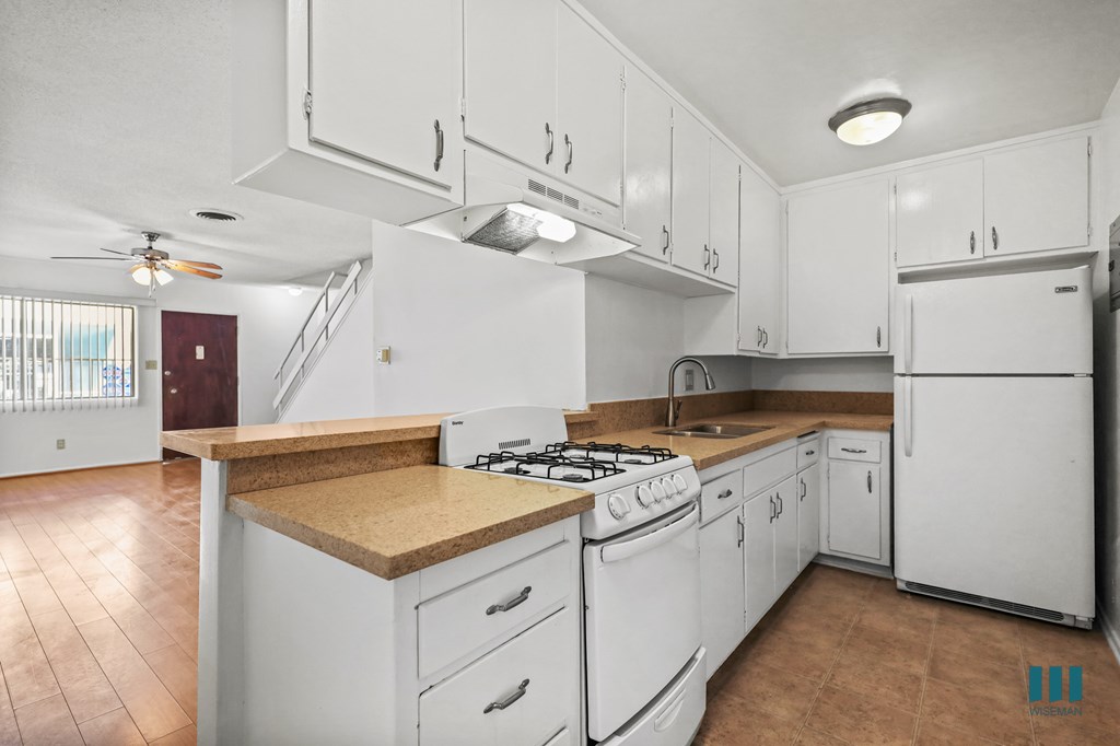 Kitchen with a Stove Oven, Refrigerator, and Ample Cabinet Storage