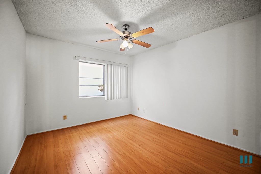 Bedroom with a Ceiling Fan and Vinyl Flooring