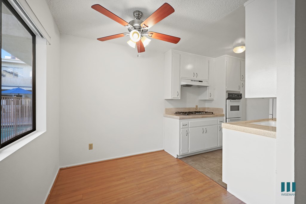 Kitchen and Dining Room with Ceiling Fan and Windows