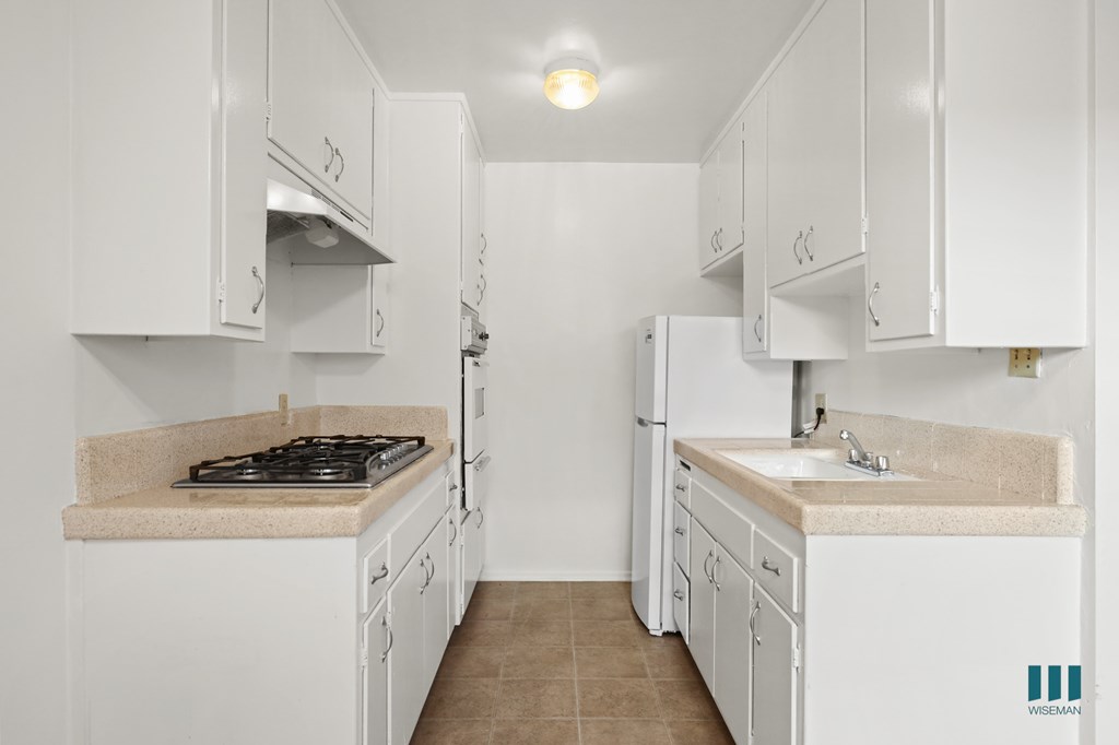 Kitchen with a Refrigerator, Range Stovetop, and Oven