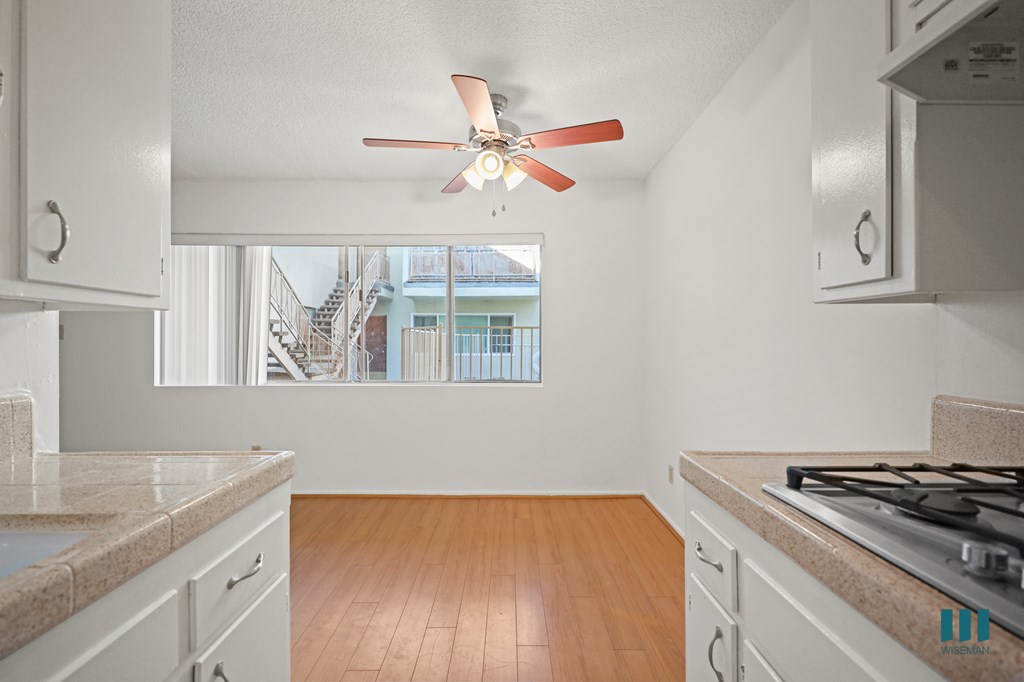 Kitchen and Dining Room with Windows and a Ceiling Fan