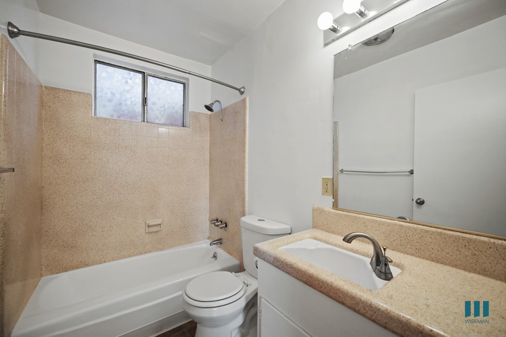 Bathroom with Shower Bath, Window, and Vanity Cabinet Storage