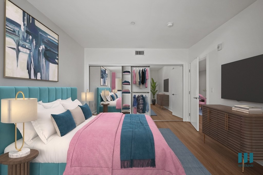 Spacious Bedroom with a Mirrored CLoset with Shelving, Vinyl Flooring, and Recessed Lighting