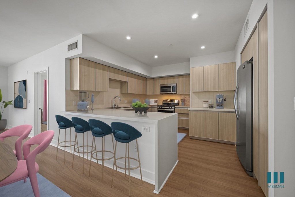 Kitchen with Countertop Bar, Stainless-Steel Appliances, and Ample Cabinet Storage