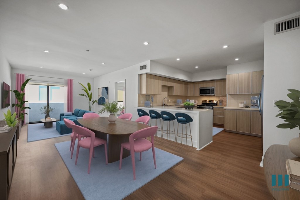 Open-Concept Kitchen with Countertop Bar, Dining, and Living Room with Patio