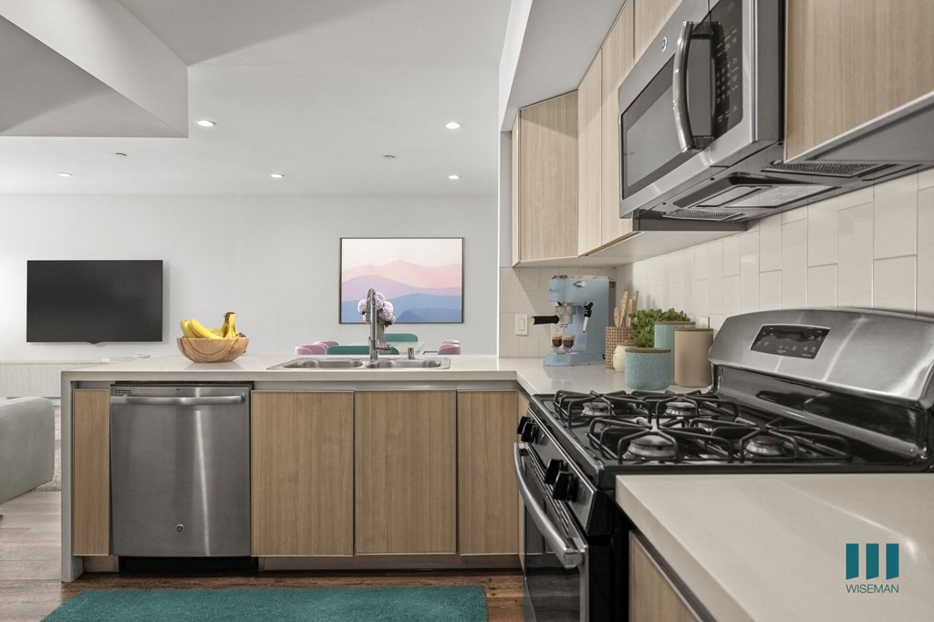Open-Concept Kitchen with Stainless-Steel Appliances and a Countertop Bar