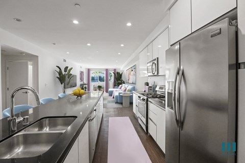a large kitchen with stainless steel appliances and a sink