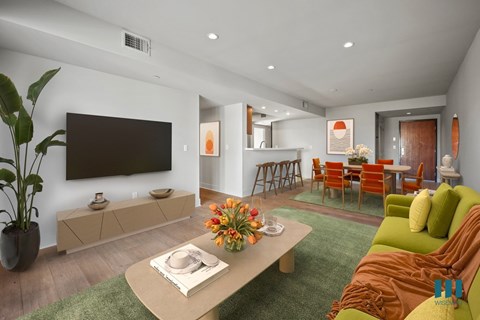A living room with a green couch and a wooden coffee table.
