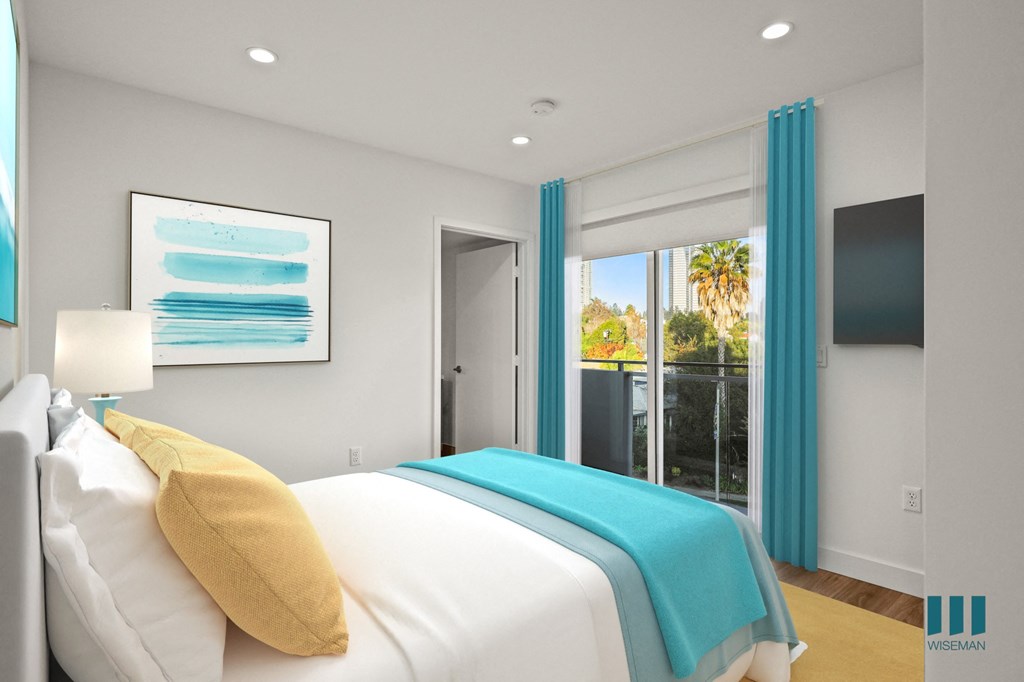 A bedroom with a white bed and a painting on the wall.