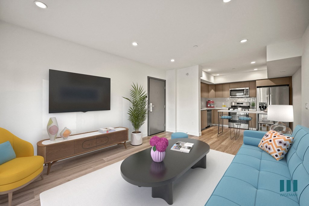 A modern living room with a yellow chair and a blue couch.