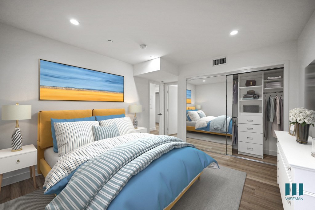 A bedroom with a large bed and a painting on the wall.