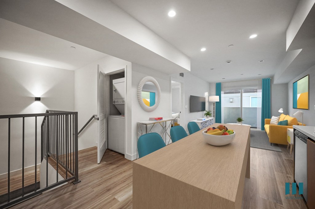 A modern kitchen with a wooden island and blue chairs.