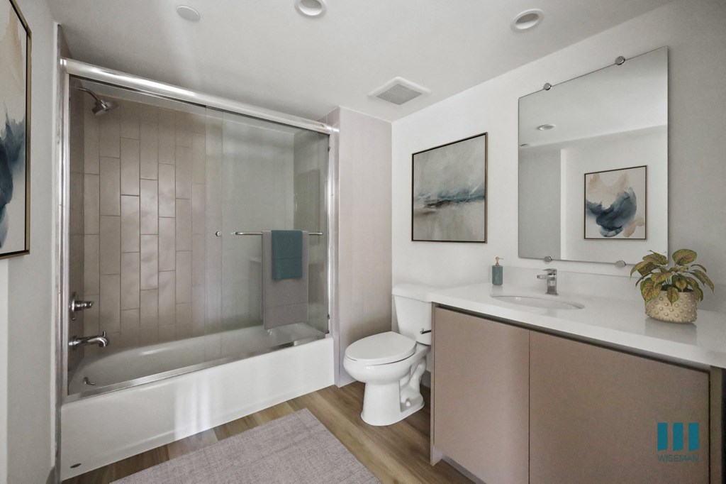 a bathroom with a shower and a toilet and a sink