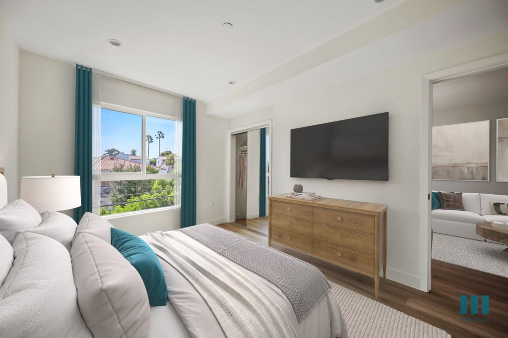 a bedroom with a large bed and a tv