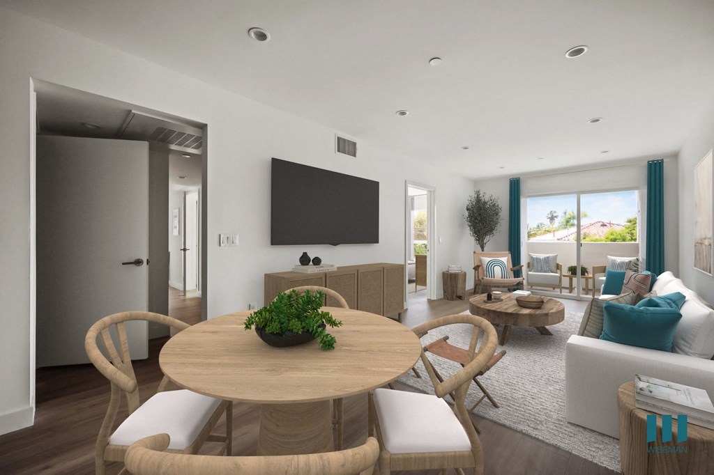 a living room and dining room with a table and chairs