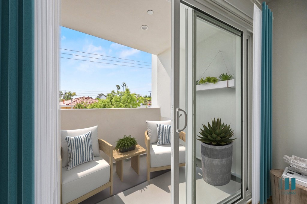 a patio with two chairs and a table and a sliding glass door