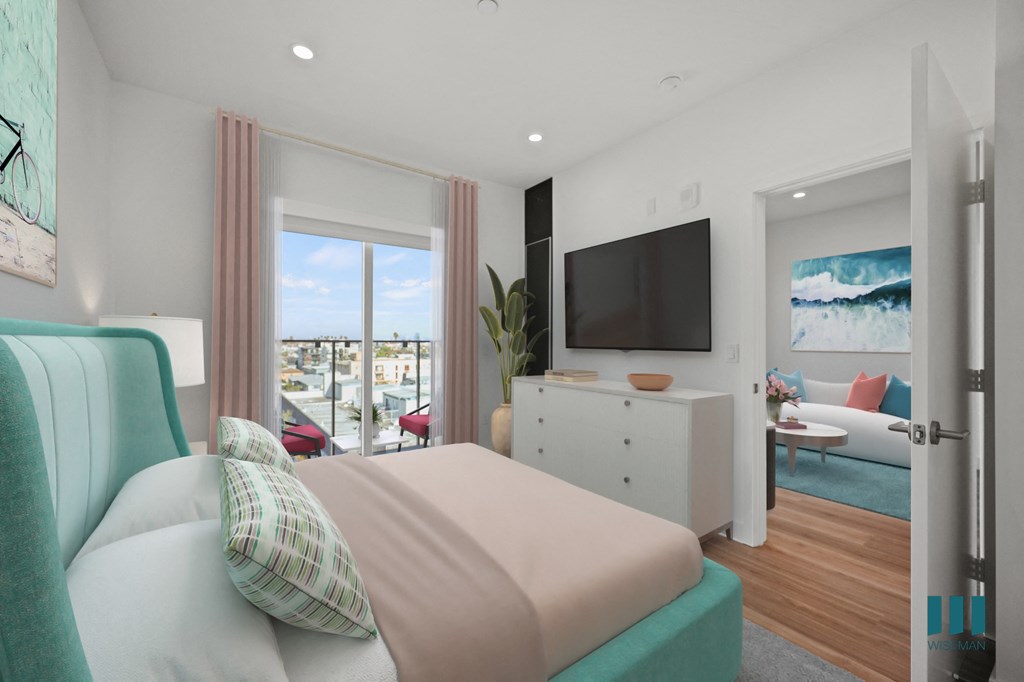 A bedroom with a large bed and a flat screen TV mounted on the wall.