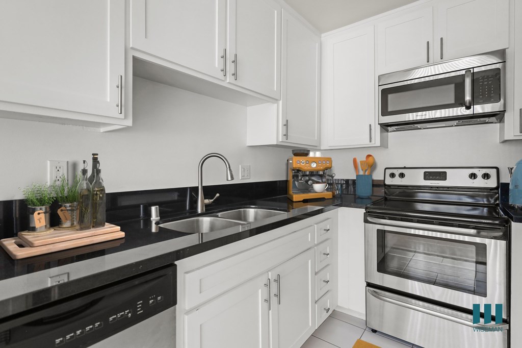 Kitchen with Stainless-Steel Dishwasher, Stove, Microwave Oven, and Refrigerator