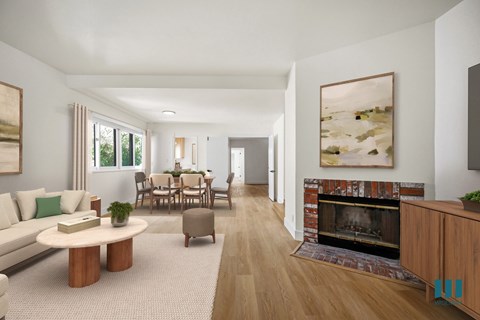 A living room with a fireplace and a painting on the wall.