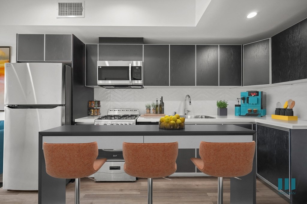 Open-Concept Kitchen with Stainless-Steel Appliances and Ample Cabinet Storage