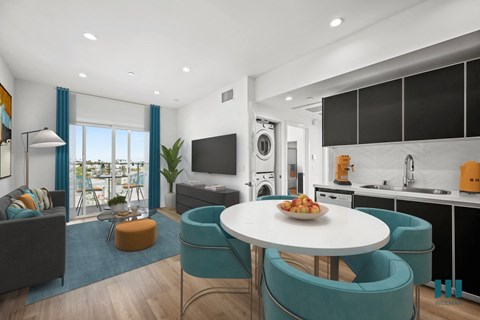 A modern kitchen with a dining table and chairs.