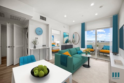A living room with a white table and a bowl of green apples on it.