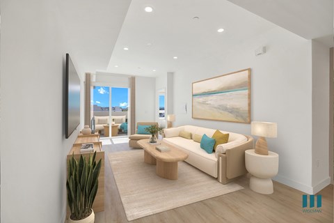 A living room with a large painting on the wall and a couch with a green pillow.