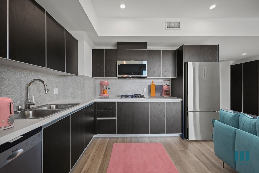 Kitchen with Refrigerator, Range Stovetop, Microwave Oven, Dishwasher, and Ample Cabinet Storage - Sherman Floor Plan