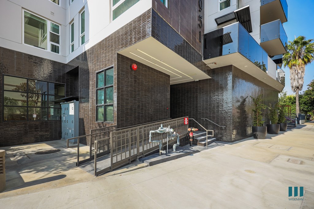 A modern building with a glass facade and a red light on.