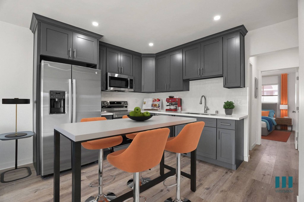 Open-Concept Kitchen with Stainless-Steel Refrigerator, Stove, Microwave Oven, and Dishwasher