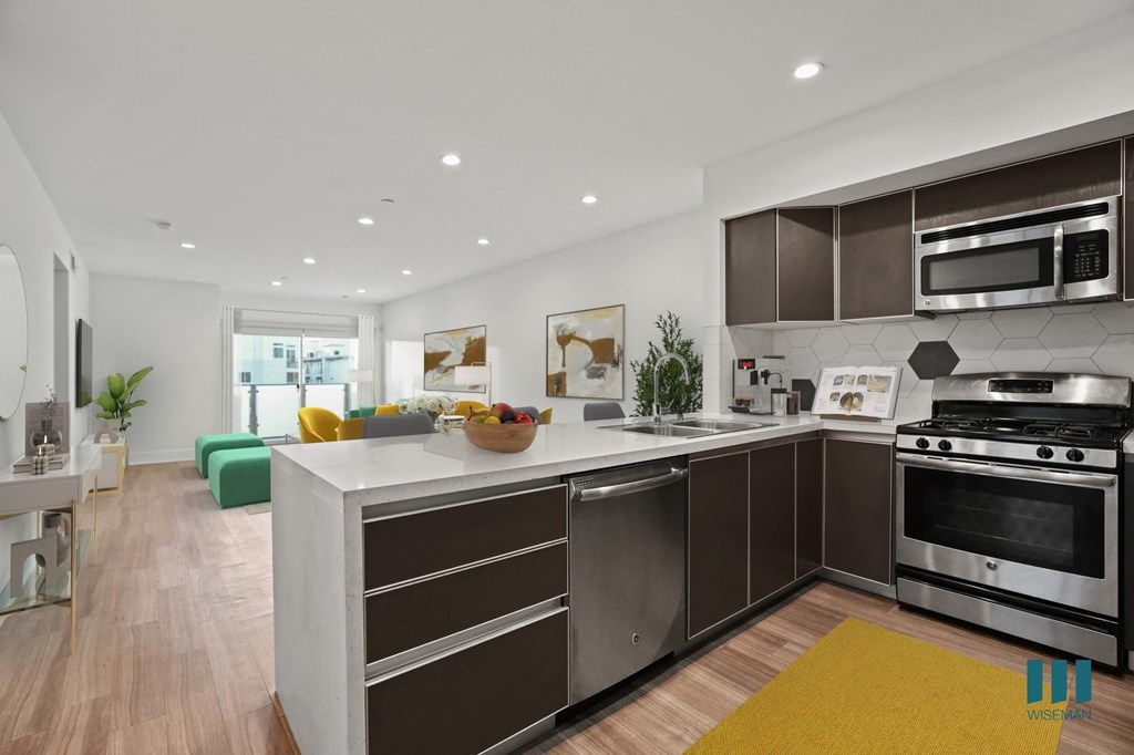 a kitchen with a large island and a stove and a microwave