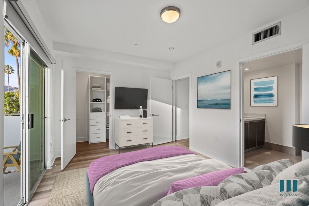 Bedroom with Walk-In Closet with Built-In Organizers, Bathroom, and Patio