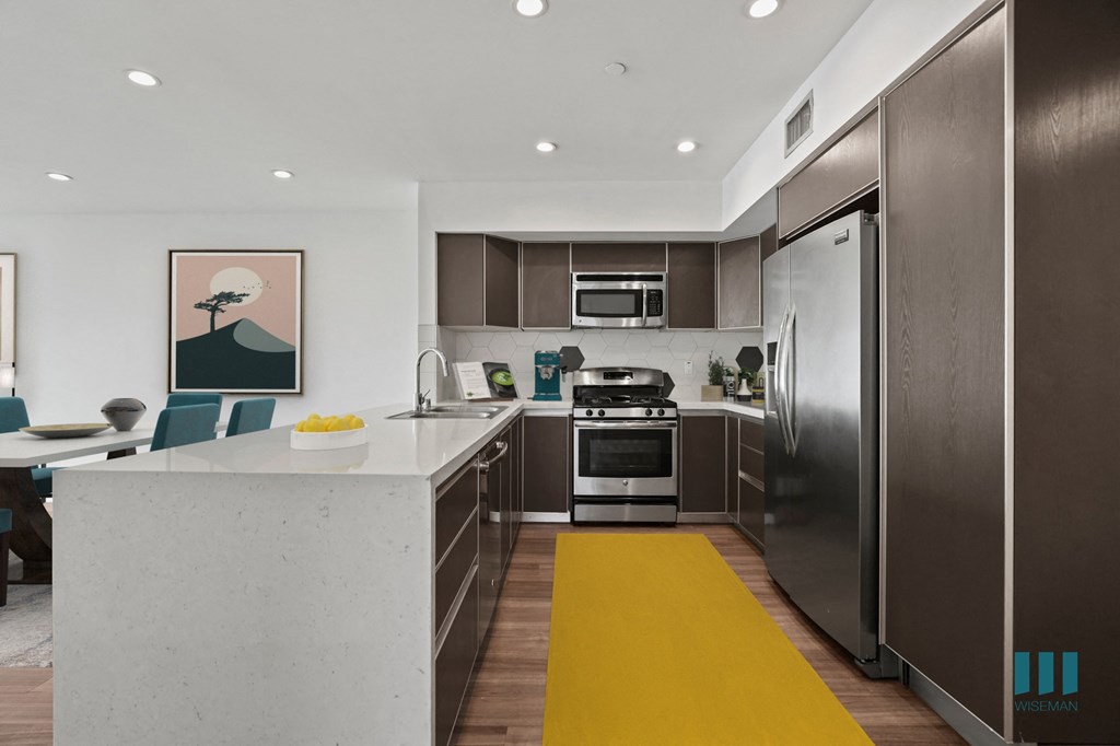 Open-Concept Kitchen with Energy-Efficient Appliances and Countertop Bar