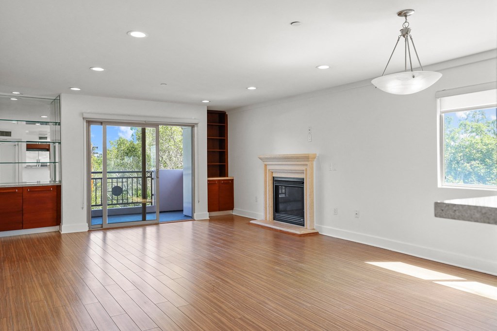 Living Room with Built-In Shelving, Patio, and Fireplace