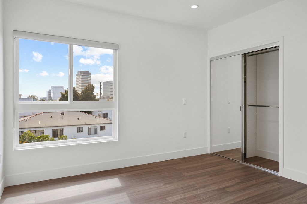 Bedroom with Closet, Windows, and Vinyl  Flooring