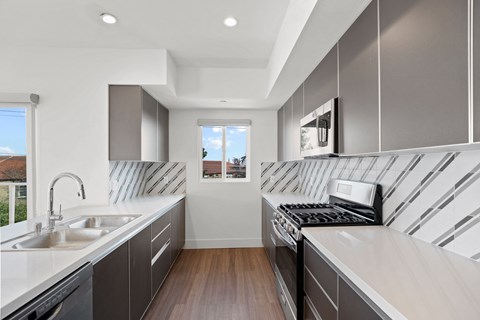 a kitchen with a sink and a stove and a window