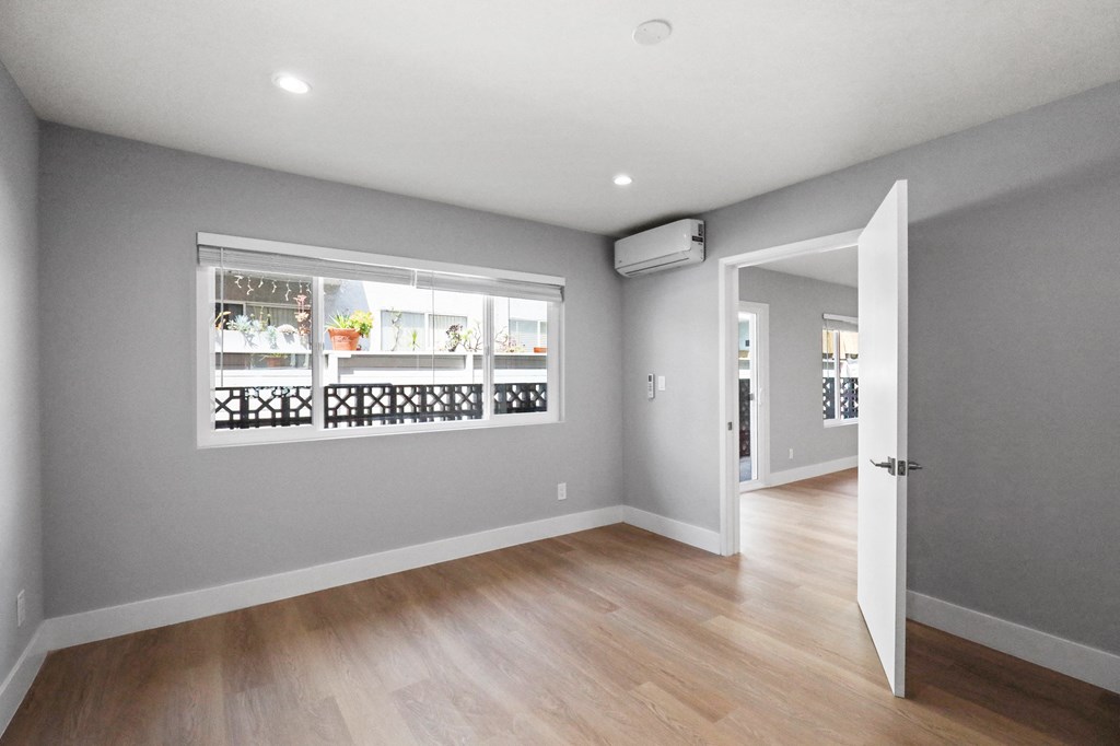 Bedroom with Vinyl Flooring, Recessed Lighting, and Large-Size Windows