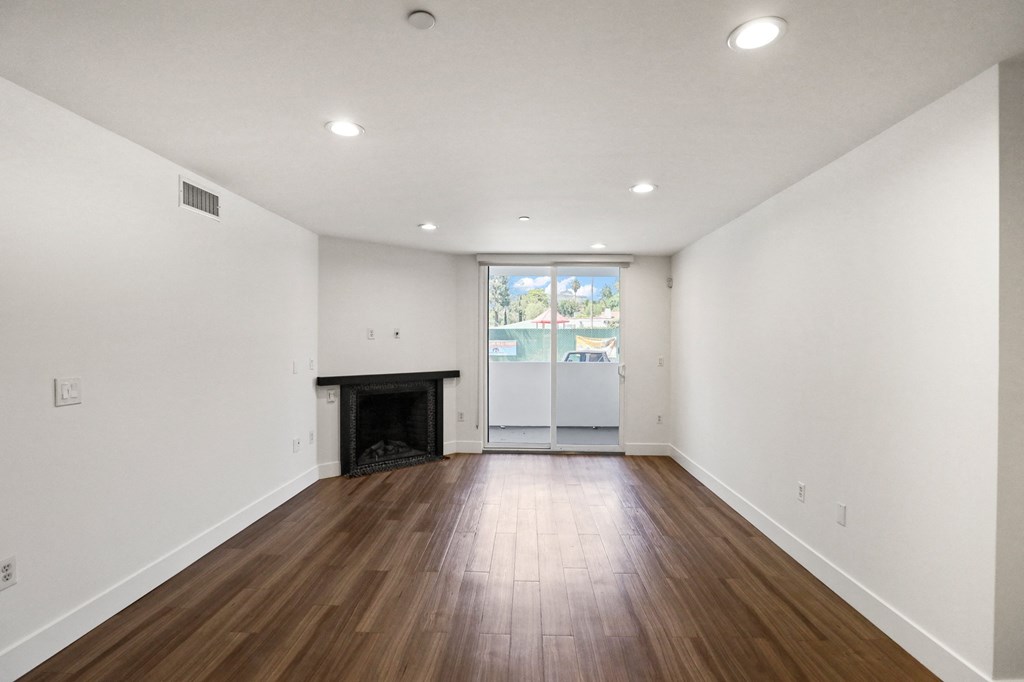 Living Room with Electric Fireplace, Recessed Lighting, Vinyl Flooring, and Patio