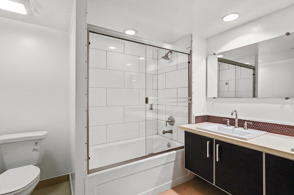 Bathroom with Full-Size Bathtub and Glass Doors