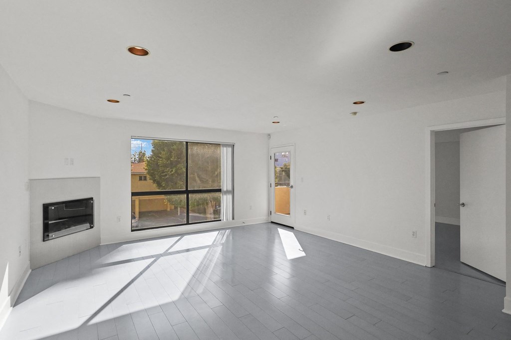 Bright & Spacious Living Room Area with Recessed Lighting and Vinyl Flooring