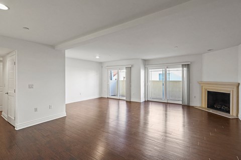 Open-Concept Dining and Living Room Areas with Electric Fireplace and Vinyl Flooring