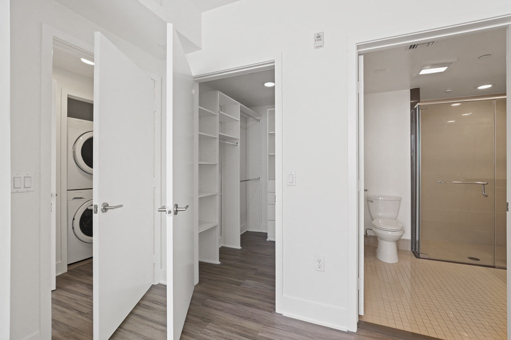 Bedroom with Walk-In Closet with Built-In Organizers and Bathroom