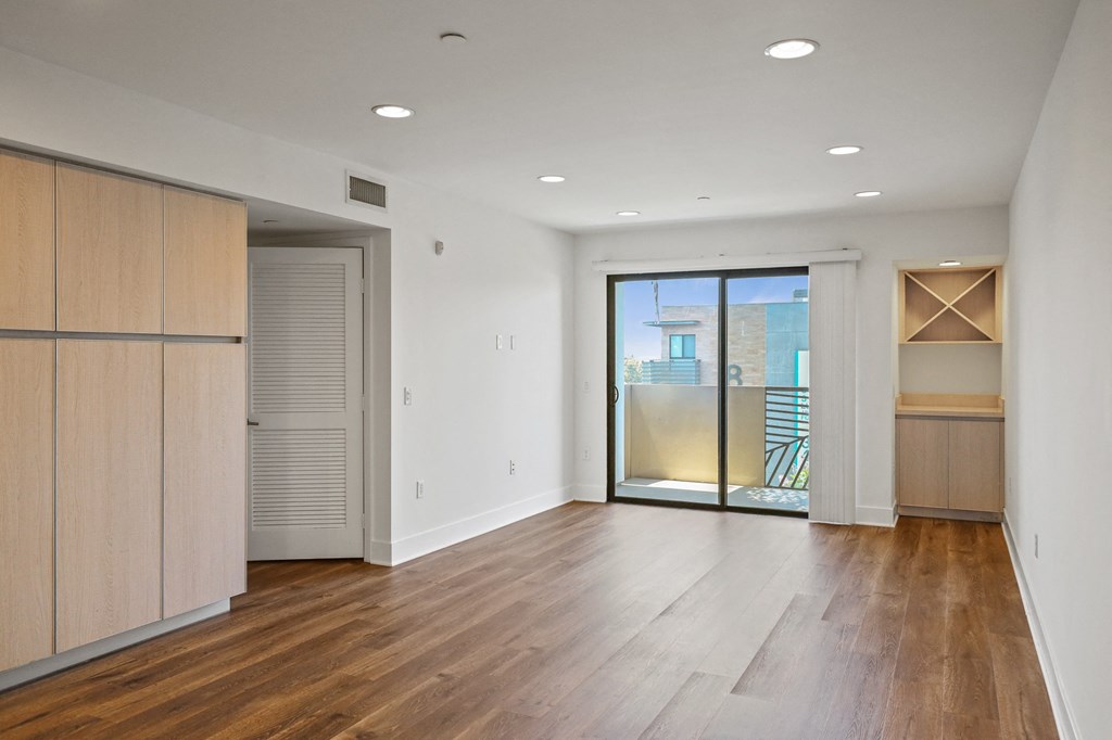 Living Room Area with Cabinet Storage , Bar, and Patio