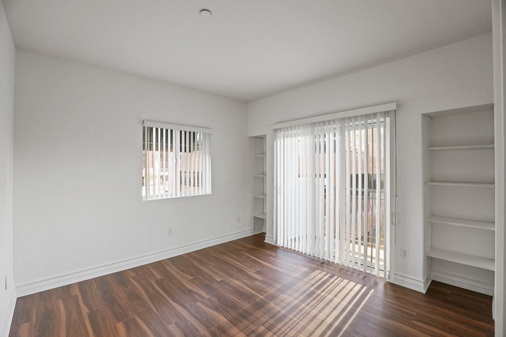 Bedroom with Built-In Shelving and Balcony