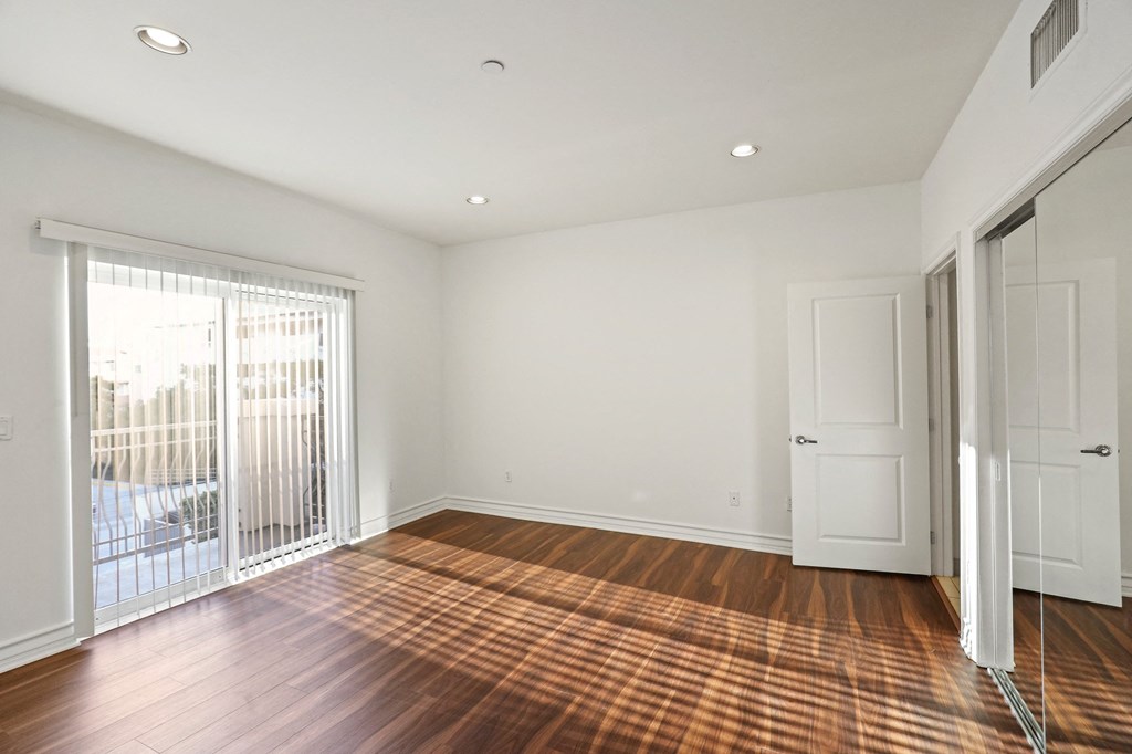 Bedroom with Closet, Balcony, and Vinyl Flooring