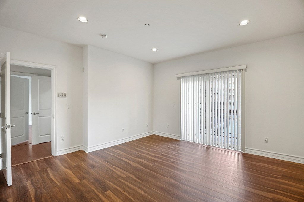 Living Room Space with In-Suite Alarm System, Recess Lighting, and Balcony