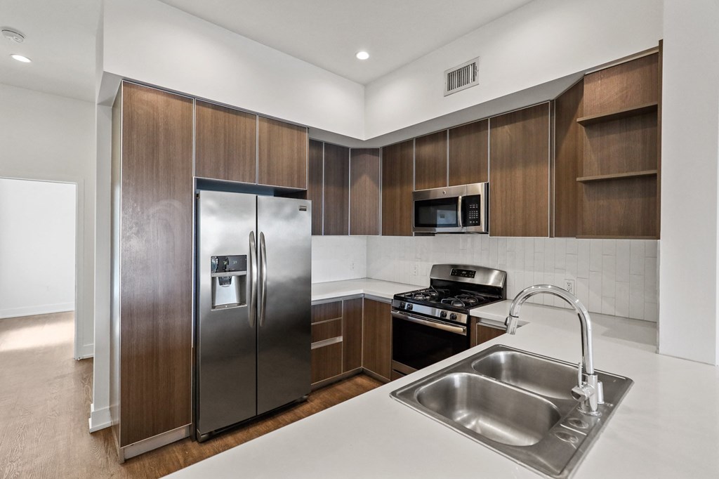 Full-Size Kitchen with Ample Cabinet Storage and Vinyl Flooring Full-Size Apartment Kitchen with Ample Cabinet Storage and Vinyl Flooring