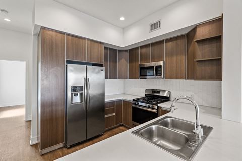 Full-Size Apartment Kitchen with Ample Cabinet Storage and Vinyl Flooring